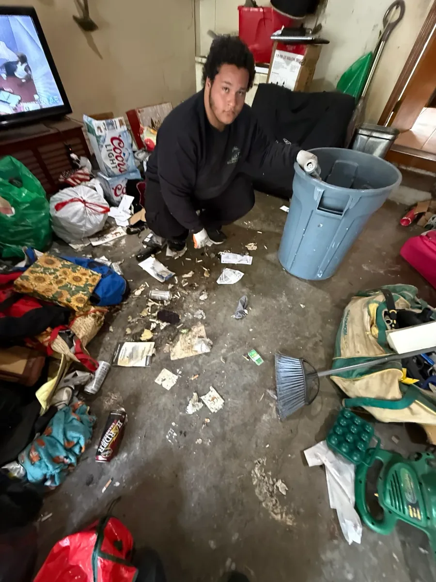 JunkPDX crew member collecting debris during a home cleanout